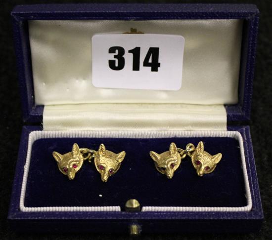 A pair of 9ct gold gem set fox-head cufflinks